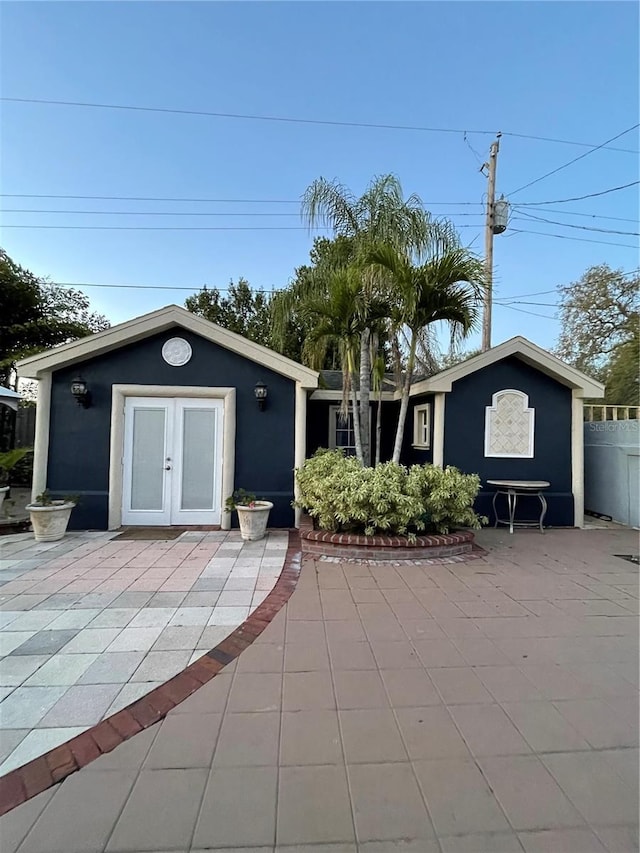 exterior space with french doors, a patio, fence, and stucco siding