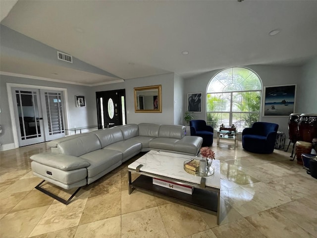 living room with vaulted ceiling, french doors, ornamental molding, and visible vents