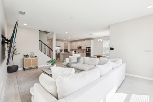 living room with recessed lighting, visible vents, stairway, and baseboards