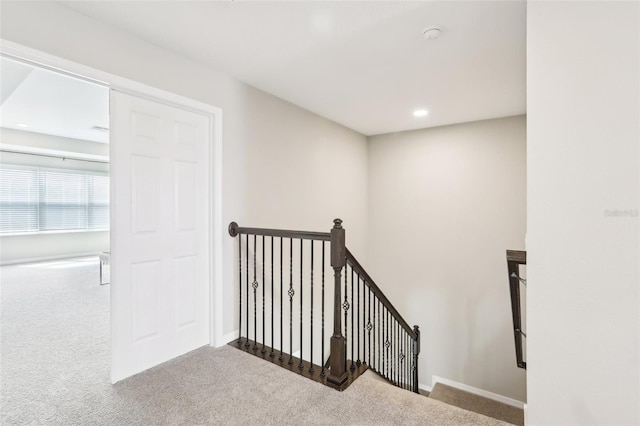 staircase with recessed lighting, carpet flooring, and baseboards