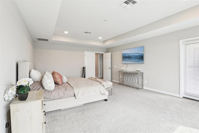 bedroom featuring baseboards, visible vents, a tray ceiling, and recessed lighting