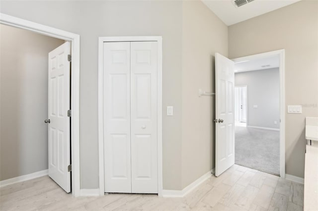 unfurnished bedroom with a closet, visible vents, and baseboards