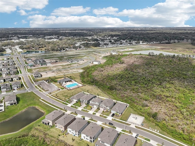 birds eye view of property featuring a water view and a residential view