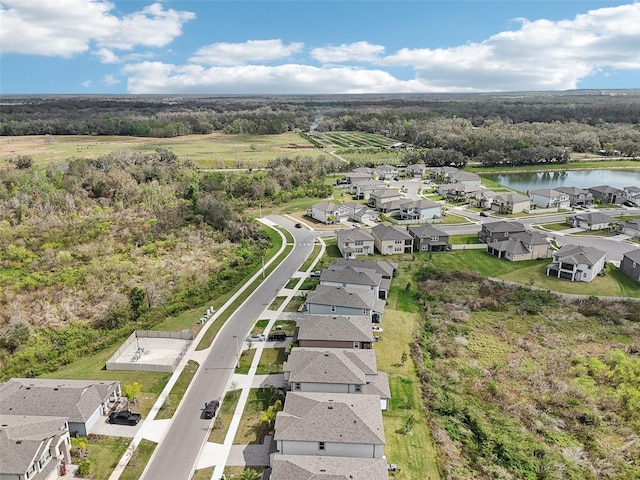 bird's eye view featuring a residential view and a water view