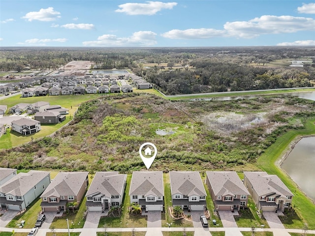 drone / aerial view featuring a water view and a residential view