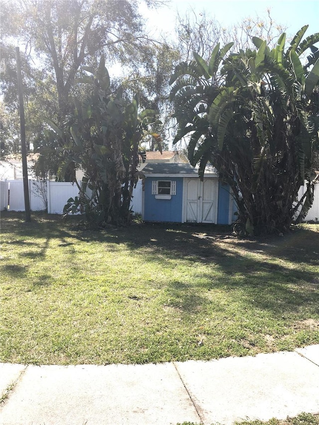 view of yard with an outdoor structure and fence