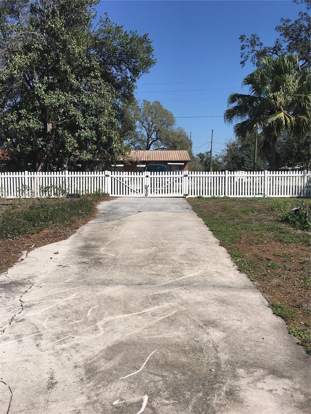 view of gate with a fenced front yard