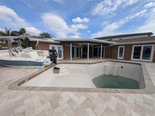 back of house featuring a patio area and a jacuzzi