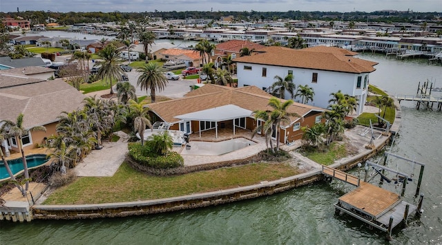 drone / aerial view with a residential view and a water view