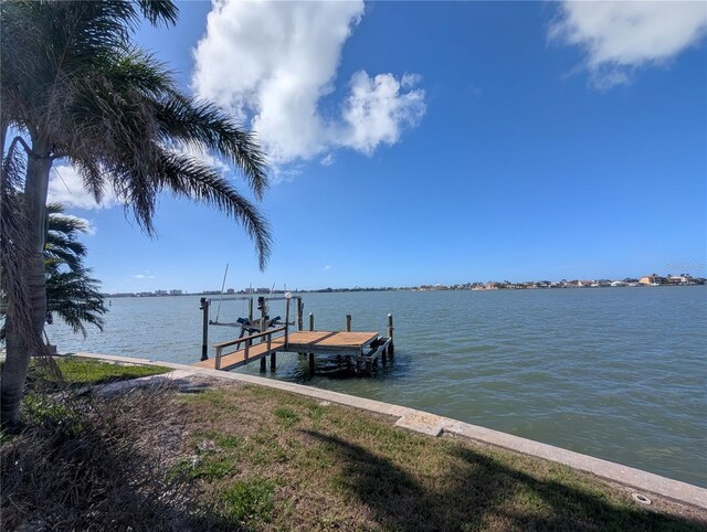 dock area with a water view and boat lift