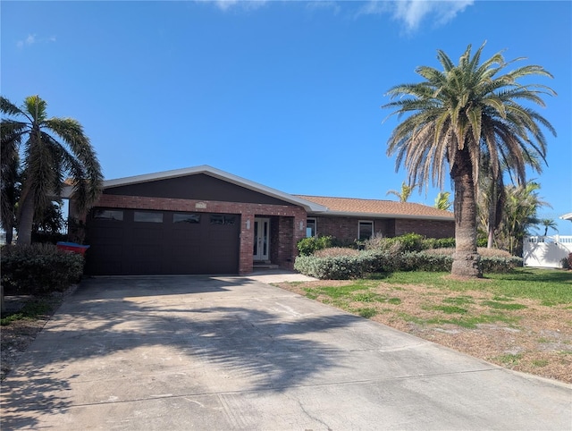 ranch-style home with an attached garage, driveway, and brick siding