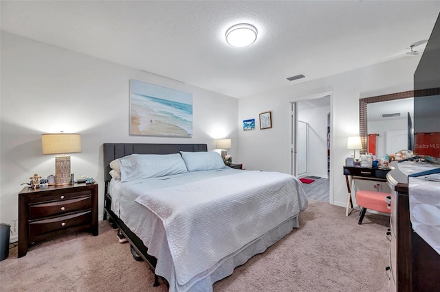 carpeted bedroom featuring a textured ceiling