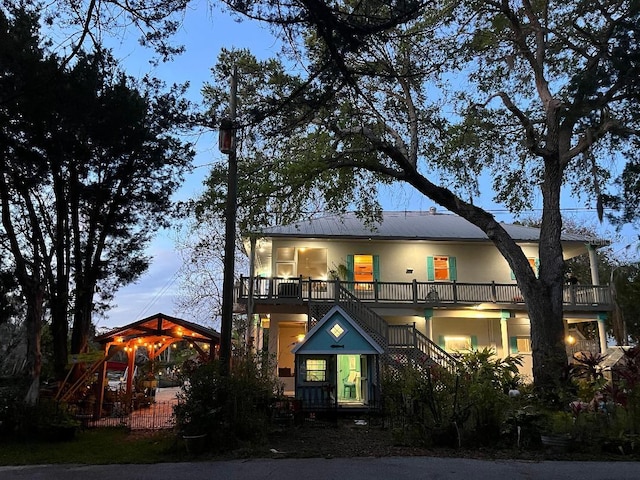 view of front facade featuring a balcony, a gazebo, and stairs