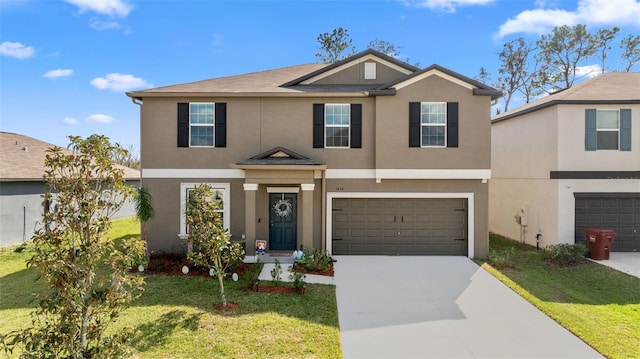 view of front of home with a front yard, driveway, an attached garage, and stucco siding