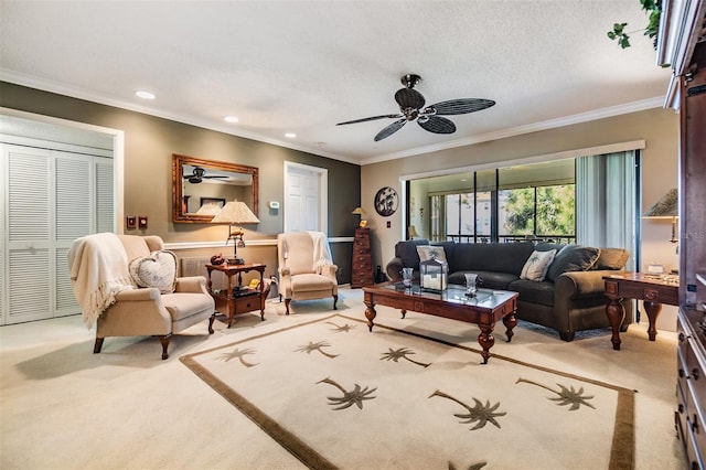 living area with ornamental molding, a ceiling fan, and light colored carpet