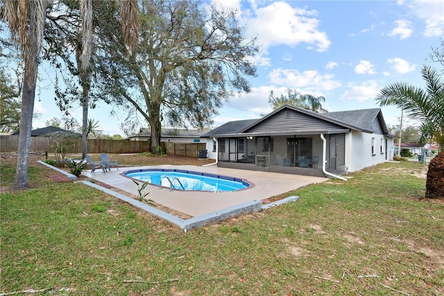 view of pool with a fenced in pool, a lawn, a patio, a sunroom, and a fenced backyard