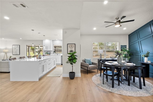 dining area featuring light wood finished floors, plenty of natural light, visible vents, and recessed lighting