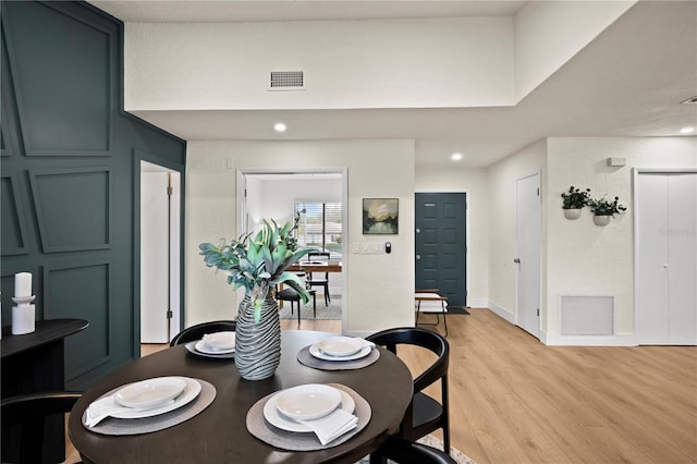 dining area with light wood-type flooring, baseboards, visible vents, and recessed lighting