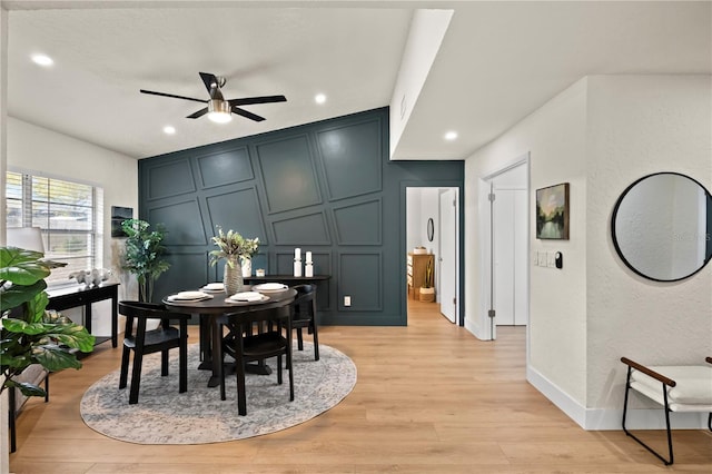 dining area with ceiling fan, recessed lighting, a decorative wall, baseboards, and light wood-type flooring