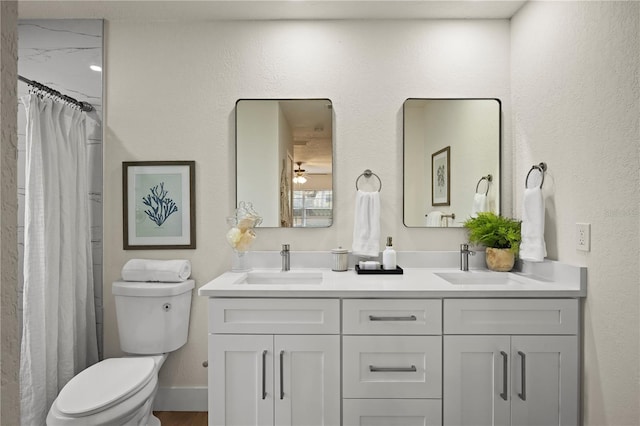 full bathroom with a sink, toilet, and double vanity