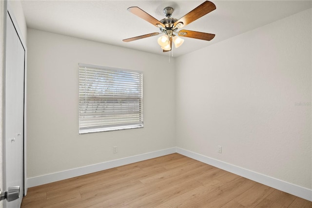 unfurnished bedroom featuring light wood-style floors, baseboards, and a closet