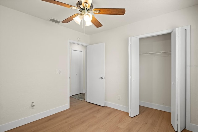 unfurnished bedroom with light wood-style floors, baseboards, visible vents, and a closet