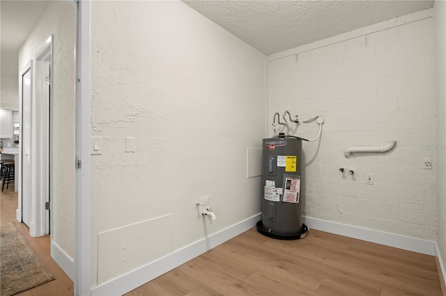 utility room featuring electric water heater