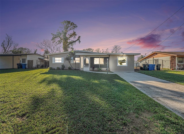 single story home featuring a yard