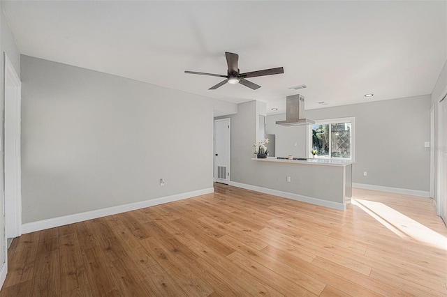 unfurnished living room featuring ceiling fan and light wood-type flooring