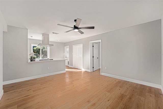 unfurnished room featuring ceiling fan and light hardwood / wood-style flooring