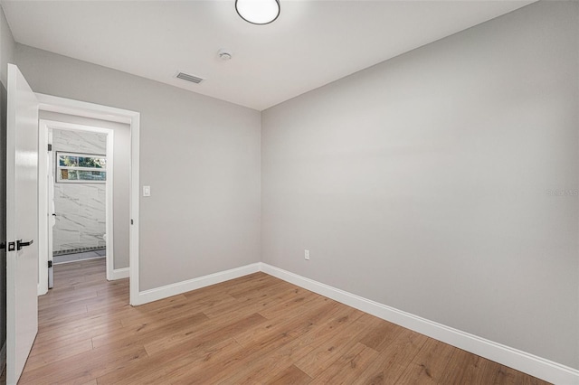 unfurnished room with light wood-type flooring