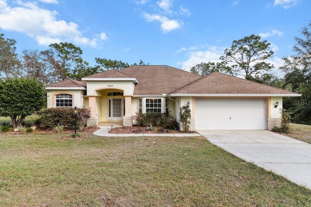 view of front of home with a garage and a front lawn