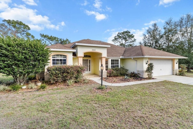 view of front of house featuring a garage and a front lawn