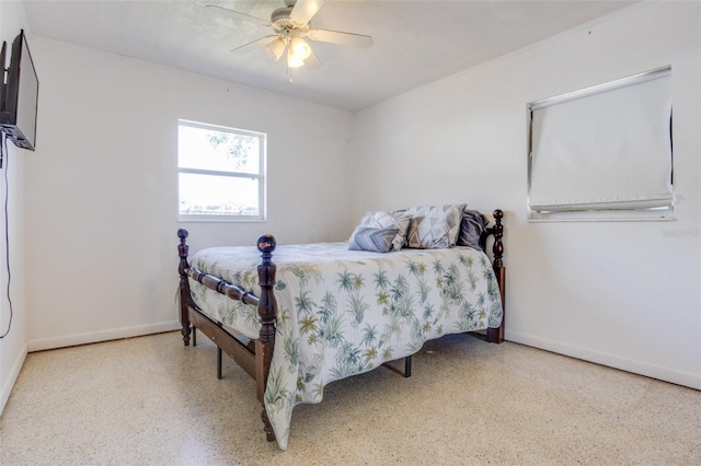 bedroom featuring light speckled floor, a ceiling fan, and baseboards