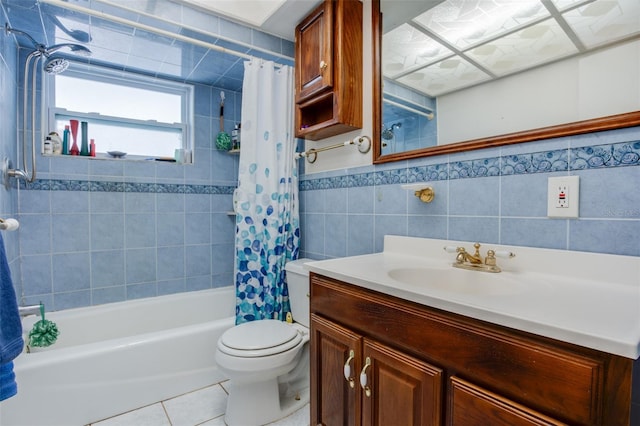 bathroom featuring toilet, shower / tub combo with curtain, tile patterned flooring, vanity, and tile walls