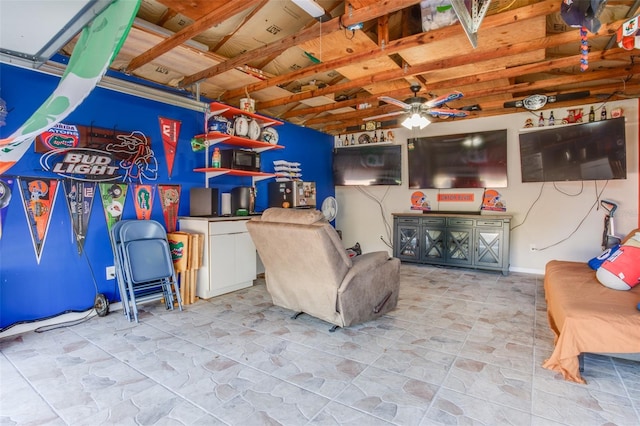 game room with ceiling fan and stone finish flooring