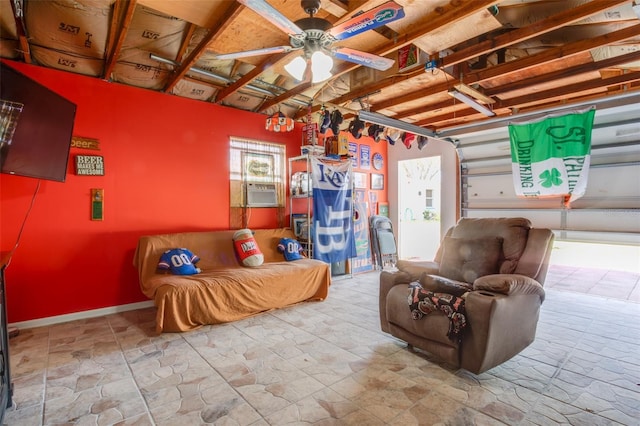 interior space featuring a garage, cooling unit, and a ceiling fan