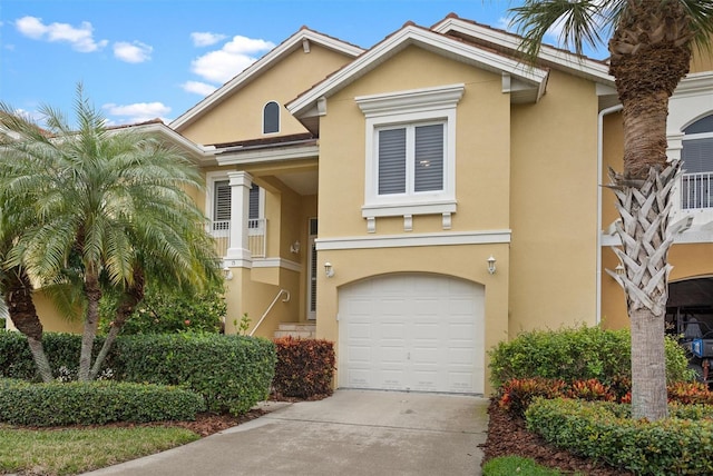 view of front of property featuring a garage, driveway, and stucco siding