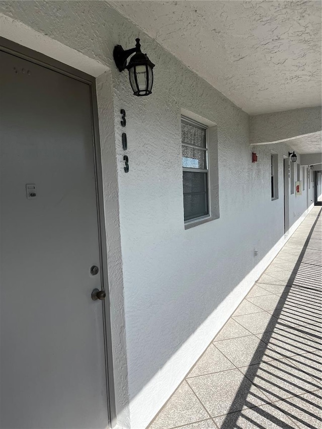 entrance to property featuring stucco siding