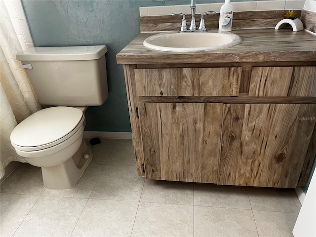 9815 47th Ave N Unit 303, Saint Petersburg, FL 33708 - bathroom with tile patterned floors, baseboards, vanity, and toilet