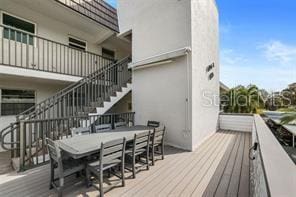 9815 47th Ave N Unit 303, Saint Petersburg, FL 33708 - deck with outdoor dining space and stairway