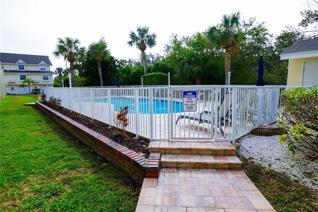 pool featuring a yard and fence