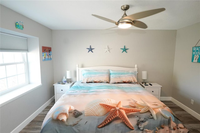 bedroom featuring dark wood-style floors, ceiling fan, and baseboards