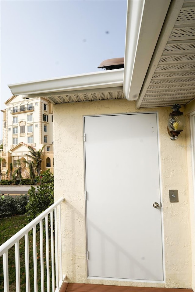 doorway to property featuring a balcony and stucco siding