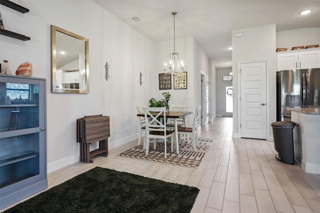 dining space featuring visible vents, baseboards, recessed lighting, light wood-style floors, and a notable chandelier