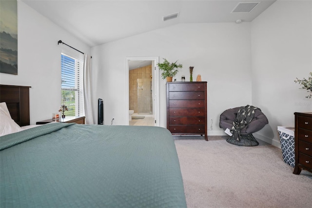 bedroom featuring visible vents, lofted ceiling, ensuite bath, and carpet flooring