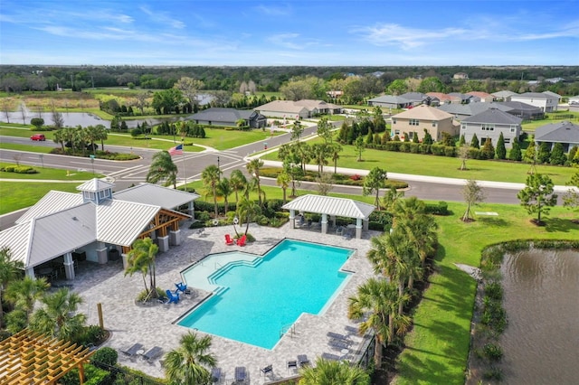 pool featuring a gazebo, a patio area, a yard, and a water view