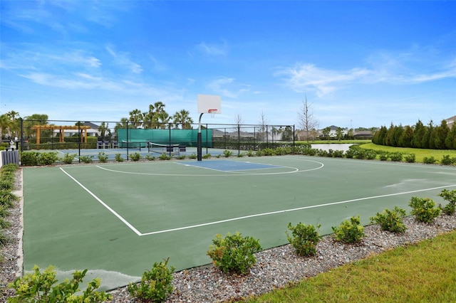 view of basketball court with community basketball court and fence