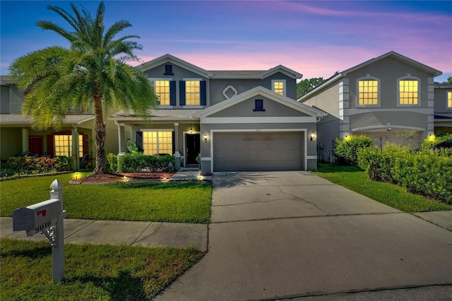 traditional home with driveway, a yard, and stucco siding