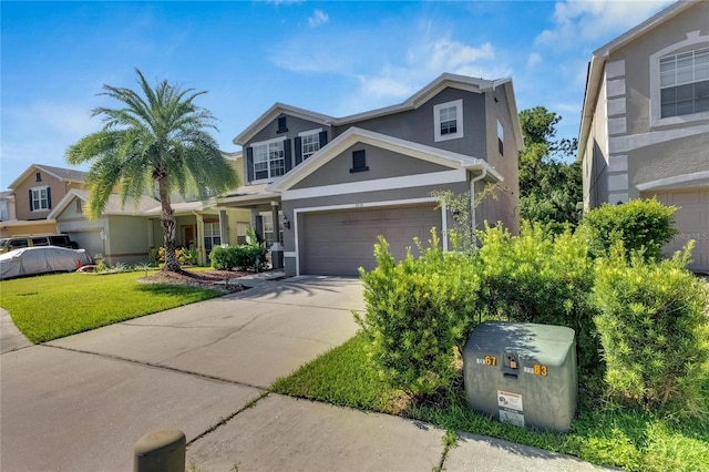 view of front of house featuring a garage, driveway, a front lawn, and stucco siding